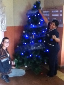 Tía Magdalena and Tía Bicelia decorate the tree in Pedacito de Cielo