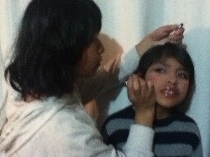 Adriana meticulously does Bryssa's make-up